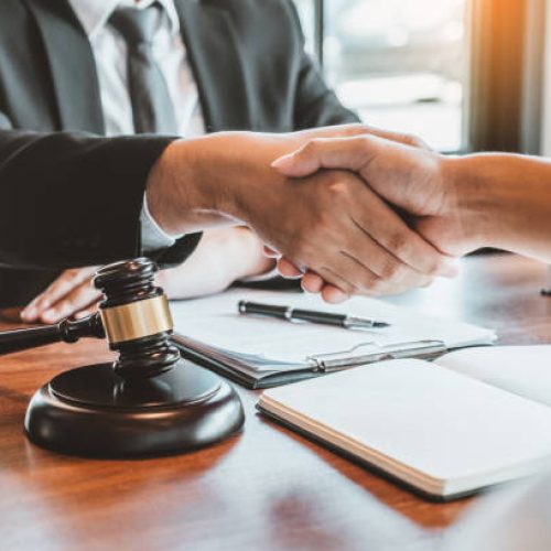 Businessman shaking hands to seal a deal Judges male lawyers Consultation legal services Consulting in regard to the various contracts to plan the case in court.